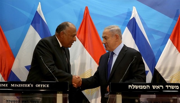 Israeli Prime Minister Benjamin Netanyahu (R) shakes hands with Egyptian Foreign Minister Sameh Shoukry after giving a joint statement prior to their meeting at his Jerusalem office.