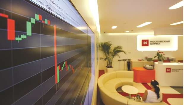 An electronic board displays a drop in the stock price index curve at the Micex-RTS Moscow Exchange (file). The Micex reversed losses and gained 0.6% on Friday.