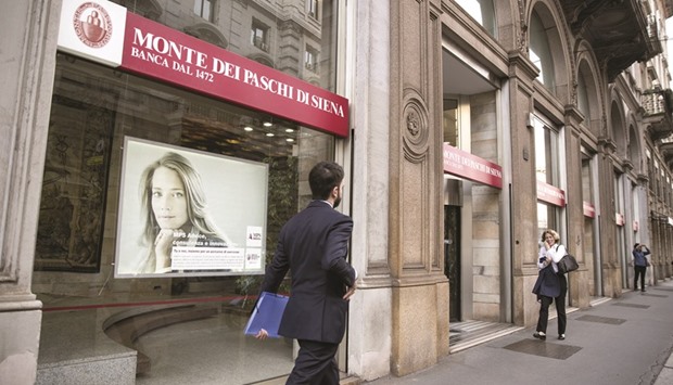 Pedestrians pass by a Banca Monte dei Paschi di Siena branch in Milan. Monte Paschi stock has lost 78% this year compared with a 35% decline in the STOXX Europe 600 Banks Price Index.