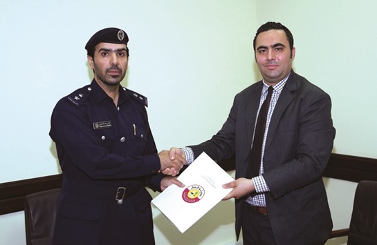 Lt Col Khamis Saif al-Mansouri and Anas Mishal after signing the contract for the mobile dental clinic.