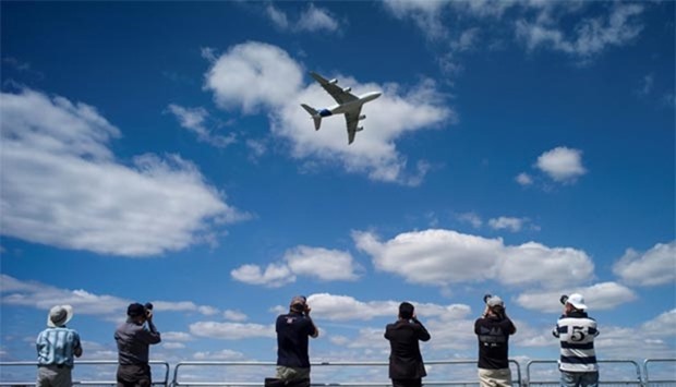 An Airbus Industrie A380 aircraft performs a manoeuvre during its display at the 2014 Farnborough International Airshow in Farnborough, southern England.