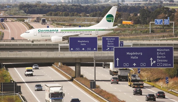 A Germania airplane crosses a connection bridge over a highway near the airport in Leipzig. The privately-held German carrier operates a mixed fleet of Airbus and Boeing jets but has said it aims to harmonise its fleet by switching to all-Airbus aircraft when it takes older Boeing 737-700s out of service.