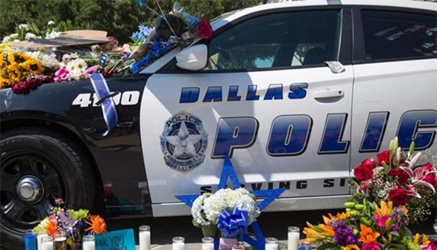 Flowers and candles adorn a memorial outside the Dallas Police Headquarters. The gunman who opened fire on Dallas officers told negotiators he wanted to kill white cops, the city's police chief said.