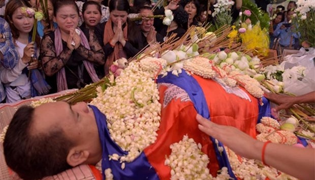 Cambodians pay their respects during the funeral ceremony of political analyst Kem Ley at a pagoda in Phnom Penh on Monday.
