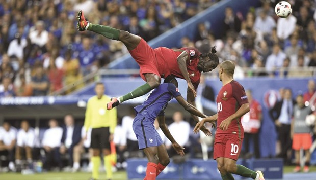 Portugalu2019s forward Eder tumbling over Franceu2019s midfielder Blaise Matuidi during the Euro 2016 final football match  at the Stade de France in Saint-Denis, north of Paris, yesterday.