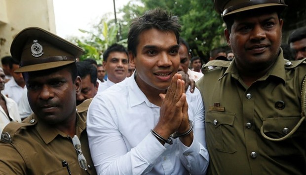 Namal Rajapaksa (C), son of former Sri Lanka's President Mahinda Rajapaksa, leaves with prison officers at the court after being arrested in Colombo, Sri Lanka.