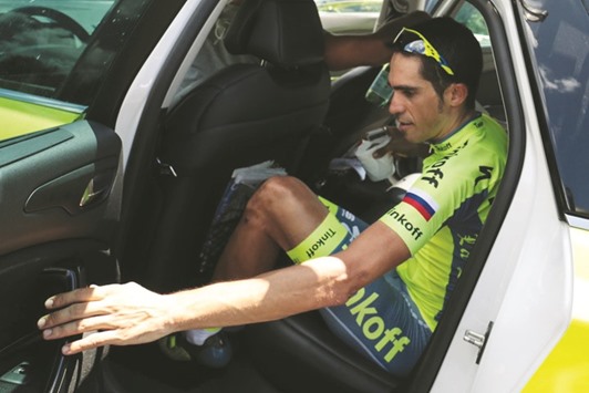 Spainu2019s Alberto Contador gets in his team car after dropping out of the 184.5km ninth stage of the 103rd edition of the Tour de France cycling race on Sunday. (AFP)