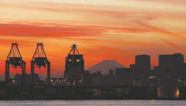 Mt Fuji is seen between cranes and buildings during sunset at a port in Tokyo. Japanu2019s cabinet office data published yesterday showed a 1.4% fall in core orders, a highly volatile data series regarded as an indicator of capital spending in the coming six to nine months, and fell well short of economistsu2019 forecast of a 2.6% gain in Reuters poll.