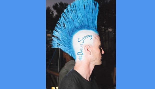 A man displays his u201cBack The Blueu201d mohawk outside the police headquarters memorial for officers killed in Dallas, Texas.