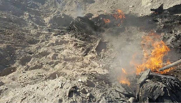 The burning remains of the crashed Syrian warplane.