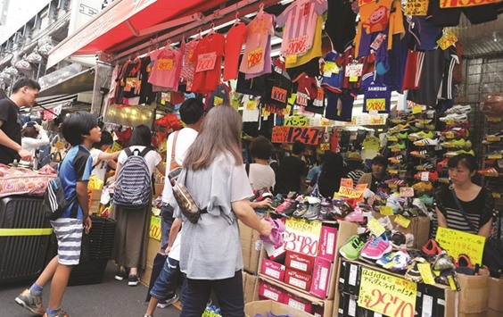 People visit a shop in Tokyo. The Bank of Japanu2019s consumer price index, which excludes both fresh food and energy costs, saw inflation hit 0.8% in May, marking the slowest pace of rise since June last year and heightening calls for the central bank to expand stimulus soon.