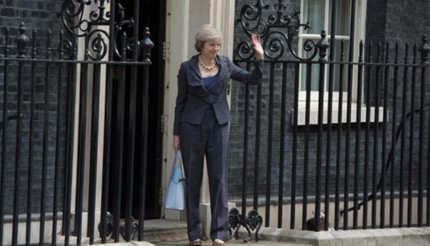 Theresa May arrives in Downing Street in London on Tuesday, as she prepares to attend Prime Minister David Cameron's last Cabinet meeting. Larry, the Downing Street cat, is seen behind the fence.