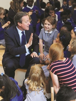 Prime Minister David Cameron speaks to pupils during a visit to Reach Academy Feltham, in south west London yesterday.