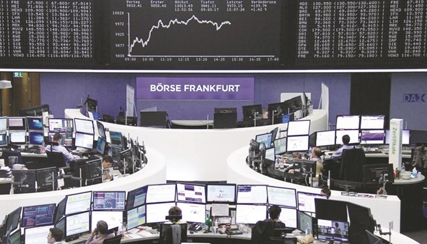 Traders work at the Frankfurt Stock Exchange. The DAX 30 closed up 1.3% to 9,964.07 points yesterday.