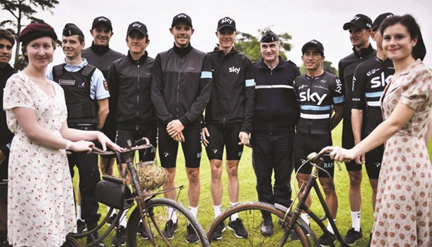 Riders of Great Britainu2019s Team Sky cycling team, including Great Britainu2019s Christopher Froome (C), pose for a photo before taking part in a parade aboard a World War II US army vehicle during the team presentation ceremony in Sainte-Mere-Eglise, Normandy, ahead of the 103rd edition of the Tour de France cycling race. The 2016 Tour de France will start today in the streets of Le Mont-Saint-Michel and end on July 24, 2016 down the Champs-Elysees in Paris.