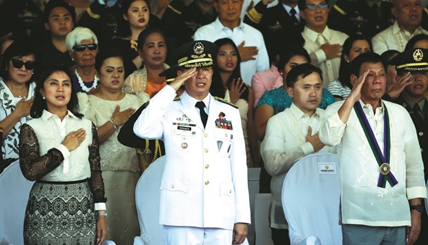 President Rodrigo Duterte, Vice President Leni Robredo (left) and outgoing Armed Forces Lt Gen Glorioso Miranda sing the Philippine national anthem at main military Camp Aguinaldo in Quezon city Metro Manila yesterday.