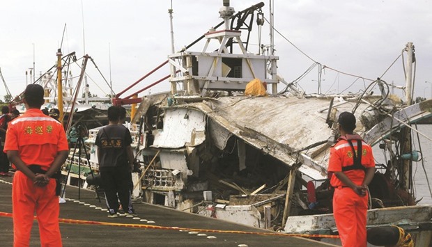 This handout photo taken and released by Taiwanu2019s Central News Agency (CNA) shows Taiwanese coastguards next to a damaged fishing boat at a harbour in southern Tainan. A Taiwanese warship mistakenly launched a supersonic u2018aircraft carrier killeru2019 missile towards China yesterday, hitting a fishing boat and killing one person, the navy said.