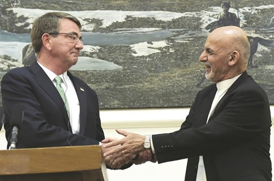 Afghan President Ashraf Ghani shakes hands with US Secretary of Defence Ash Carter during a joint press conference at the Presidential Palace in Kabul yesterday.