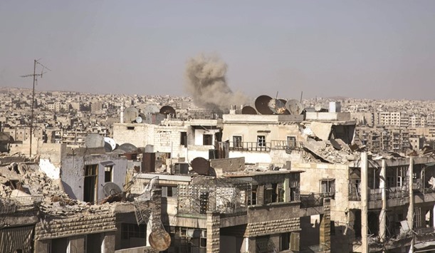 Smoke billows following a reported strike by pro-Syrian government forces in a rebel-held neighbourhood in the northern city of Aleppo yesterday.