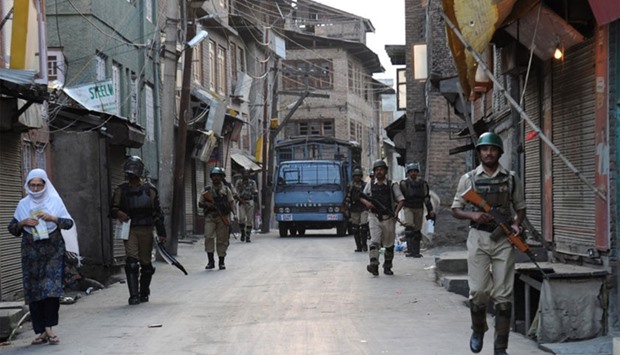 Indian paramilitary soldiers patrol the streets during a curfew in downtown Srinagar.