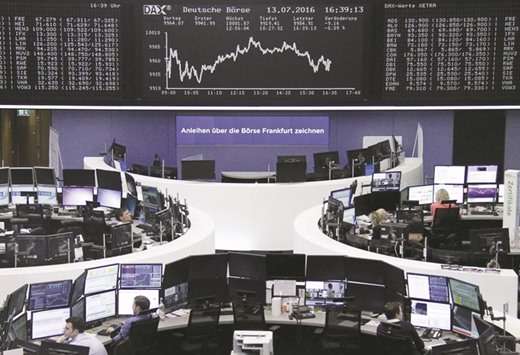 Traders work at the Frankfurt Stock Exchange. The DAX 30 dipped 0.3% yesterday.