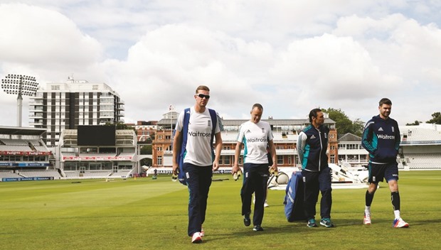 Jake Ball (left) and James Anderson (right) walk off the pitch after Englandu2019s nets session at Lordu2019s in London yesterday. (Reuters)