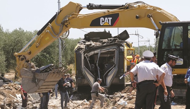 Officials inspect the train crash site near Corato.