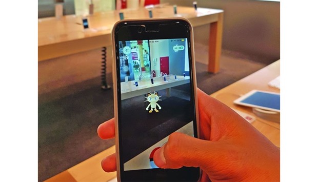 A player tries to catch a Pokemon 'creature' at a mall in Doha on Thursday. PICTURE: Joey Aguilar