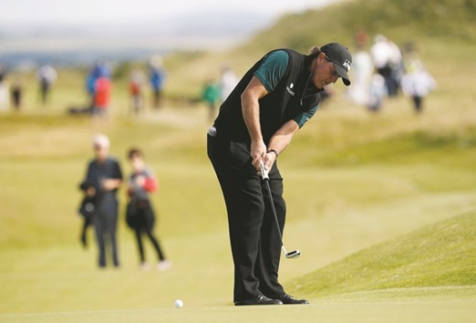 Phil Mickelson of the US putts on the 13th green during the first round of the British Open at Royal Troon, Scotland.