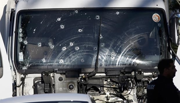 Bullet impacts are seen on the heavy truck that was driven into a crowd at high speed in Nice last week.