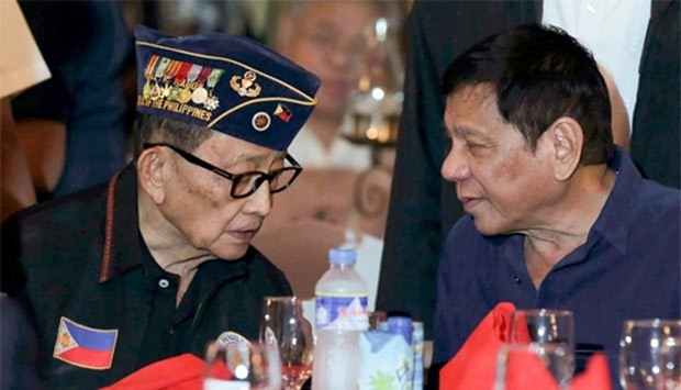 President Rodrigo Duterte speaks to former president Fidel Ramos (left) in Manila.