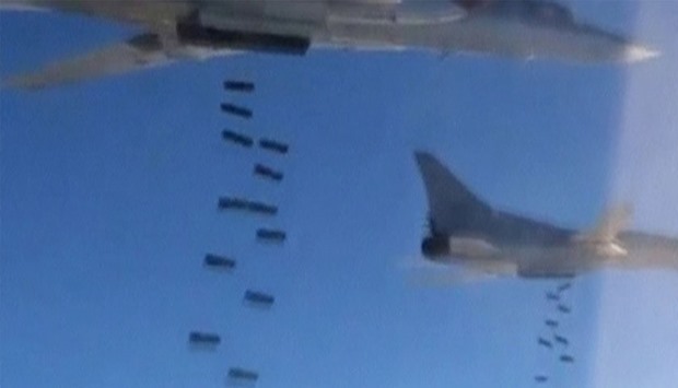 A still image, taken from video footage and released by Russia's Defence Ministry, shows Russian Tupolev Tu-22M3 long-range strategic bombers conducting an airstrike at an unknown location in Syria.