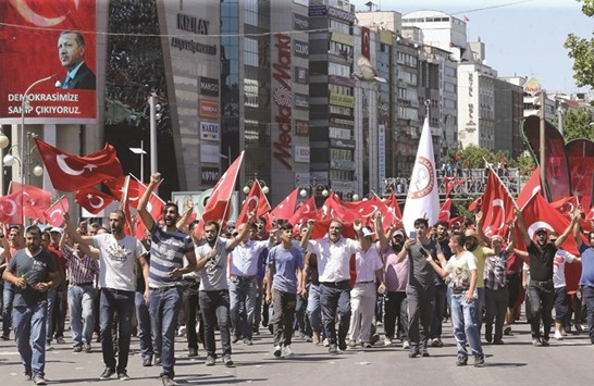 People waving national flags as they march from Kizilay square to the Turkish General Staff building in Ankara to react against the military coup attempt yesterday.