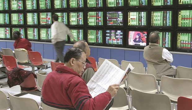 Traders keep an eye on the share prices of Taiwan Stock Exchange at a securities trading company in Taipei (file). Taiwan became the latest regional bourse to enter a bull market.