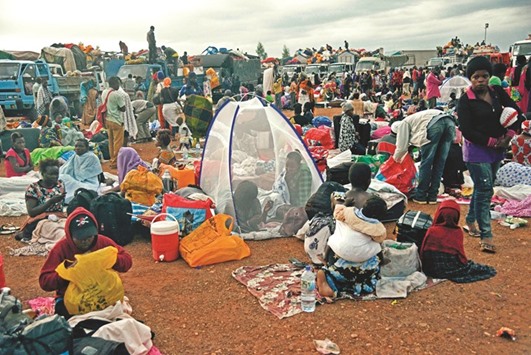 People gather inside a make-shift camp at Nimule border, in Amuru Distric in Uganda yesterday. Uganda began on Friday repatriating its nationals evacuated from Juba, the battle-scarred capital of neighbouring South Sudan.