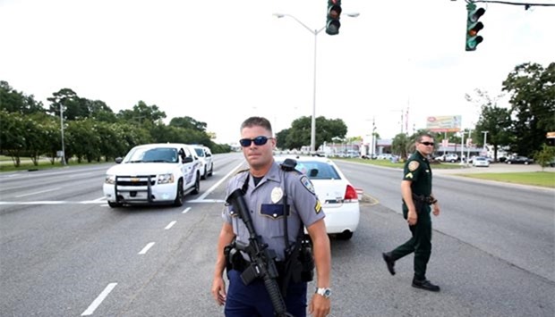 Police officers block off a road after a shooting of police in Baton Rouge, Louisiana, on Sunday.