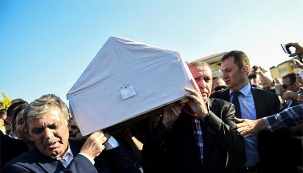 Turkey's President Recep Tayyip Erdogan carries a coffin of a victim of the coup attempt in Istanbul on Sunday.
