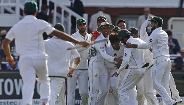 Pakistan's Mohammad Amir celebrates with teammates after taking the wicket of England's Jake Ball on the fourth day of the first Test match at Lord's on Sunday.