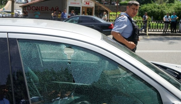 A bullet hole is seen on the window of a car parked in the street in Almaty, Kazakhstan