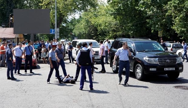 Police officers detain a man after an attack in the centre of Almaty on Monday.