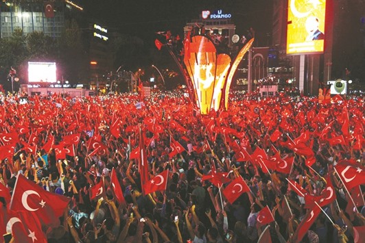 Pro-Erdogan supporters wave Turkish flags at Kizilay square in Ankara during a demonstration in support of the Turkish government following a failed coup attempt.