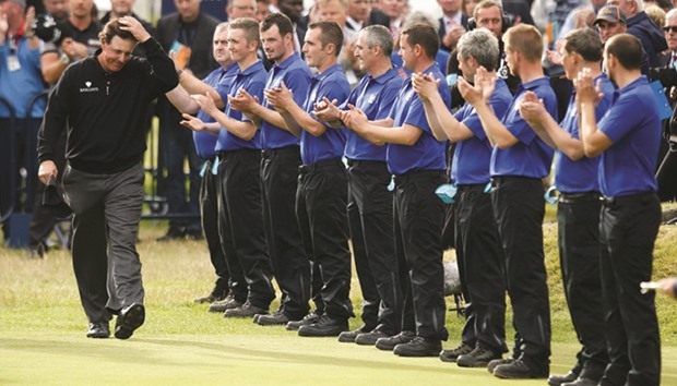Phil Mickelson of the US is applauded by green keepers after finishing as runner-up at the British Open on Sunday.