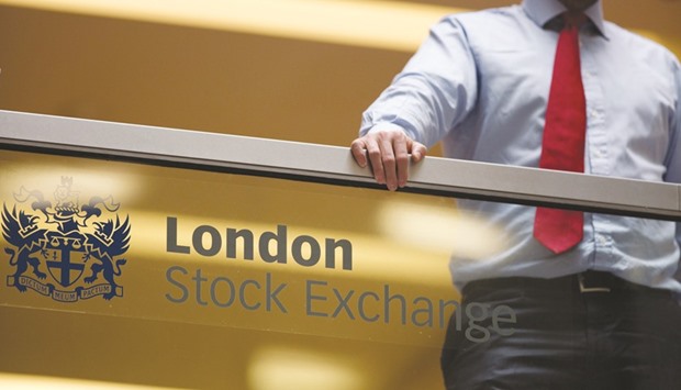 An employee leans on a glass wall above the main atrium of the LSE headquarters in London. Londonu2019s benchmark FTSE 100 index closed 0.4% higher at 6,695.42 points yesterday.