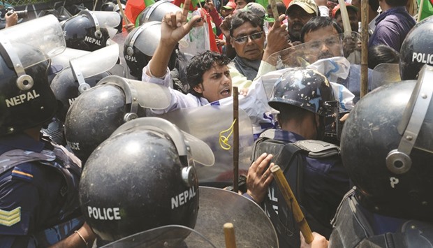 In this photograph taken on May 16, Nepalese activists from the Federal Alliance (members of the Madhesi and ethnic communities) scuffling with police as they tried to break through a police cordon during a demonstration against the government in Kathmandu.