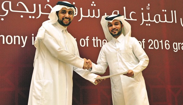 Students receiving their awards from QU president Dr Hassan Rashid al-Derham.