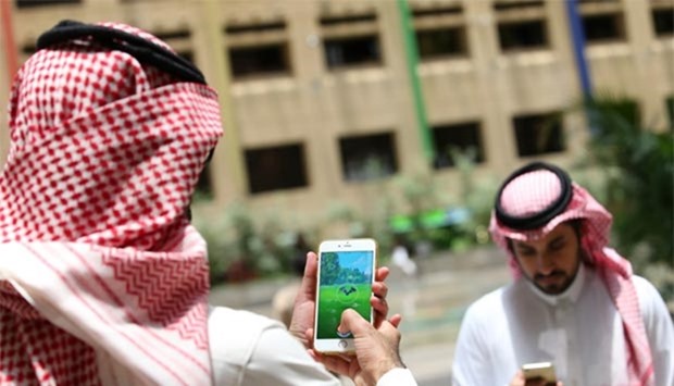 Saudi men play Pokemon Go on their mobiles in Riyadh.