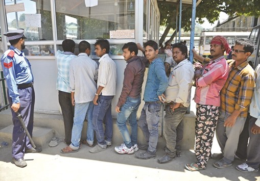 Migrant labourers wait for bus tickets so they can travel back to their respective homes at the Tourist Reception Centre in Srinagar, during a curfew yesterday. Many non-Kashmiri labourers are leaving the valley due to ongoing unrest.