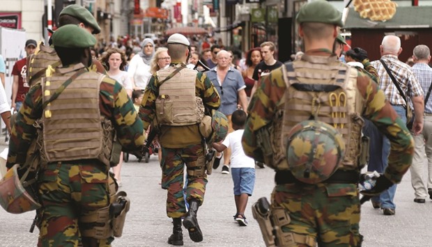 Belgian soldiers patrol a Brussels square after a man was seen wearing a thick coat with wires protruding from underneath in the city centre.