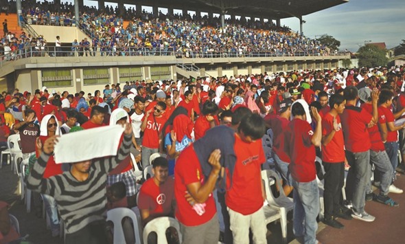 More than 10,000 drug users and pushers gather at a sports stadium after they surrendered to local government officials to take part in a government campaign against drugs in San Fernando, Pampanga, yesterday.