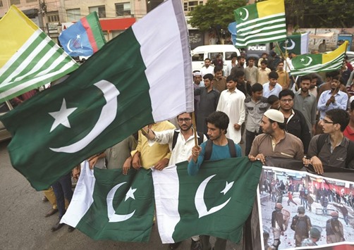 Supporters of Pakistanu2019s Islamist party Jamaat-e-Islami (JI) march at a rally to show solidarity with Indian Kashmiri Muslims as they observed a u2018Black Dayu2019 to denounce the actions of Indian security forces in Indian-administered Kashmir, in Karachi.